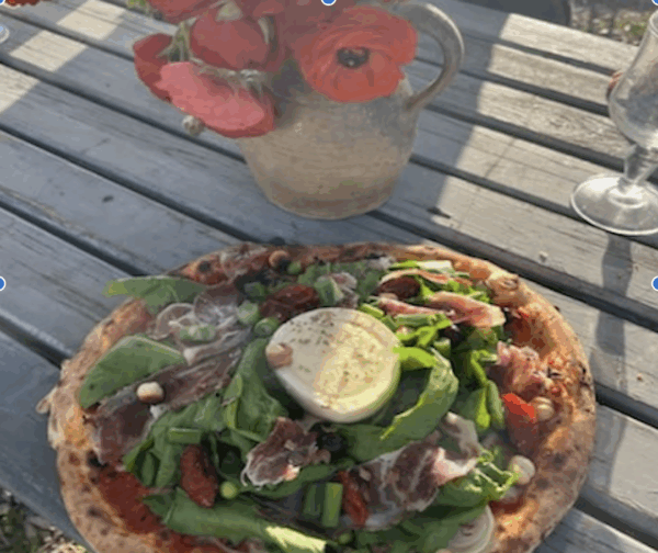 pizza "celle du moment" avec sa salade d'accompagnement